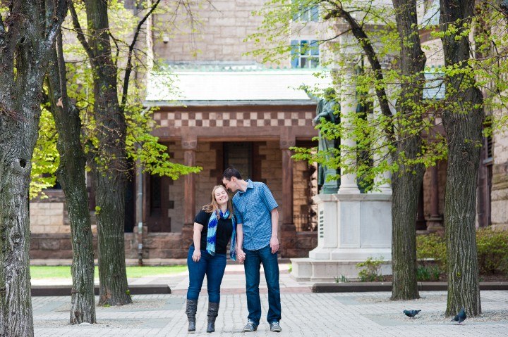 A cute couple poses for engagement photography in Copley Square Boston