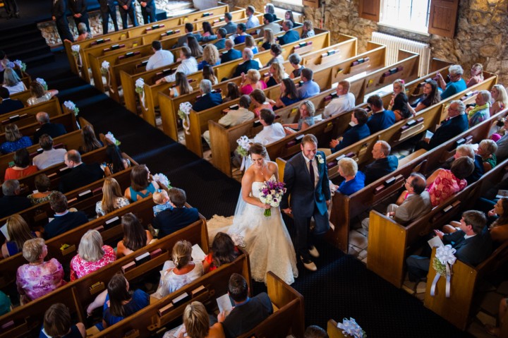 bride and groom walk down the Gaither Chapel aisle