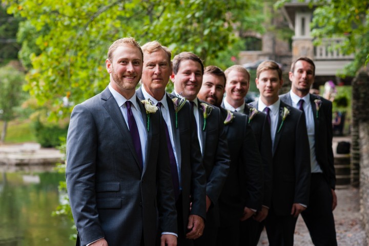 handsome groom and groomsmen pose for a moment on the bridge at Montreat College