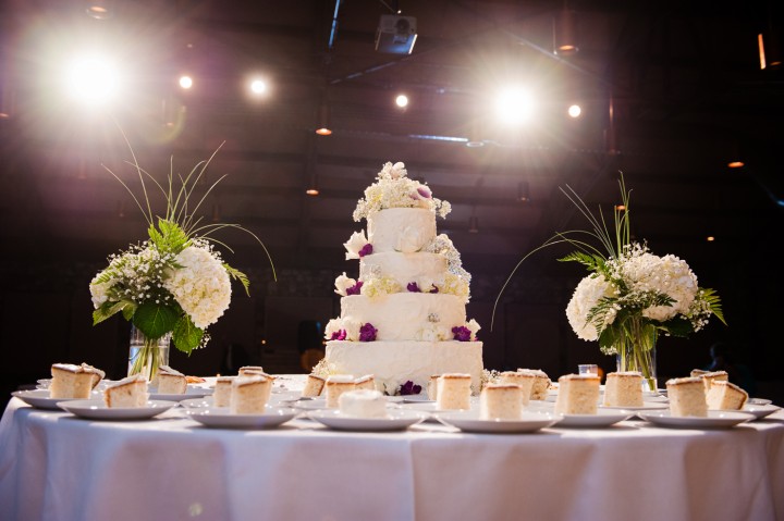 beautiful purple flowers on a traditional white wedding cake