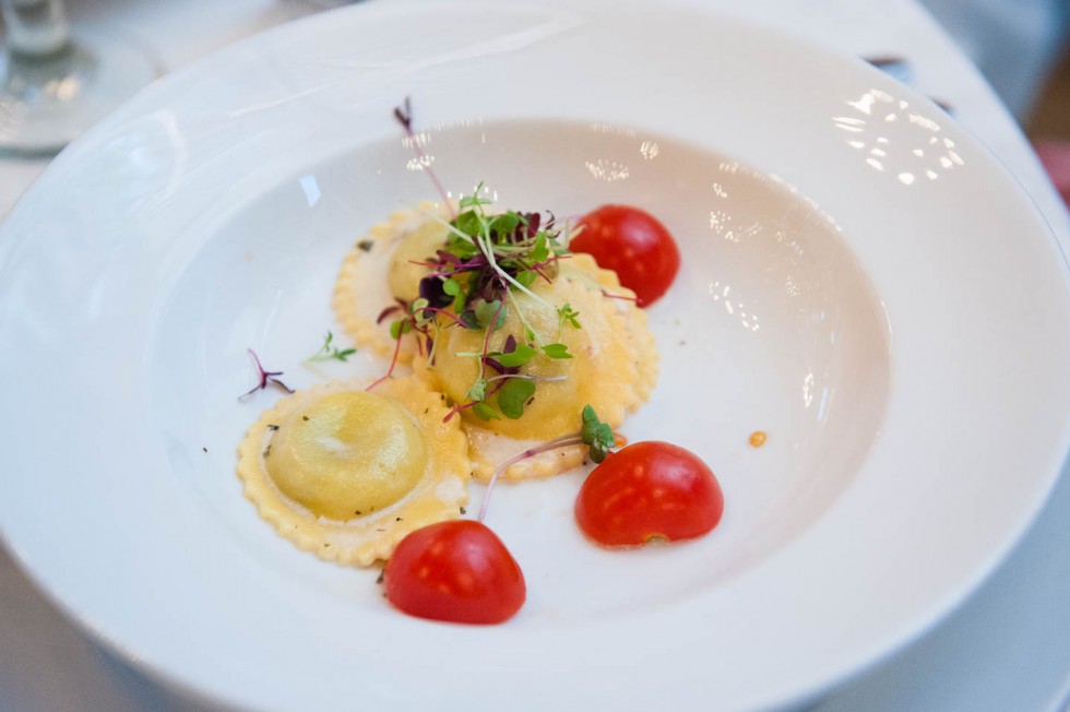 Wedding appetizer with Ravioli and cherry tomatoes on a white plate