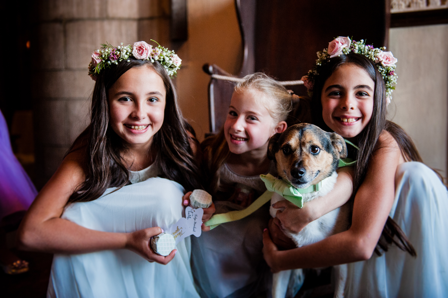 adorable flowers girls and the bride and grooms dog  smiling