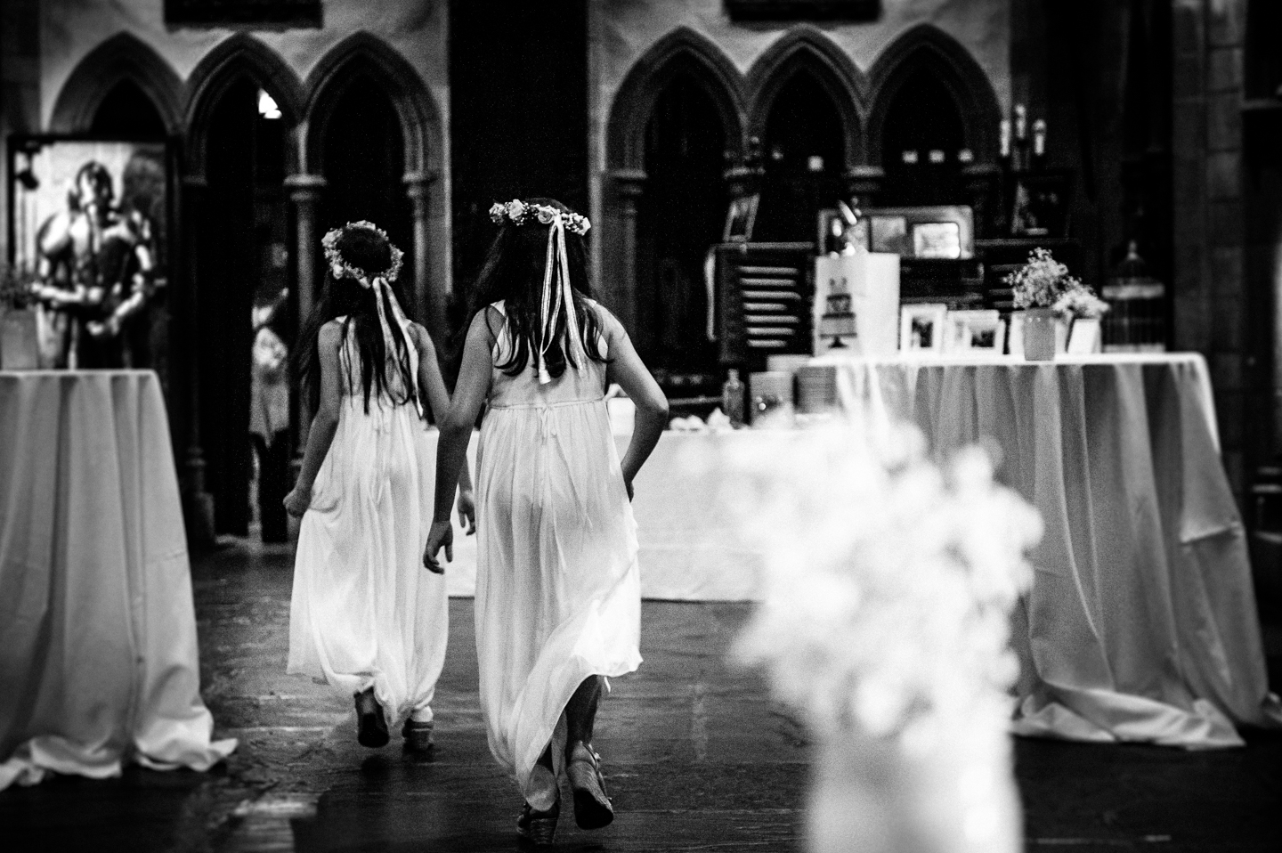 flower girls run through Hammond Castle for the wedding ceremony