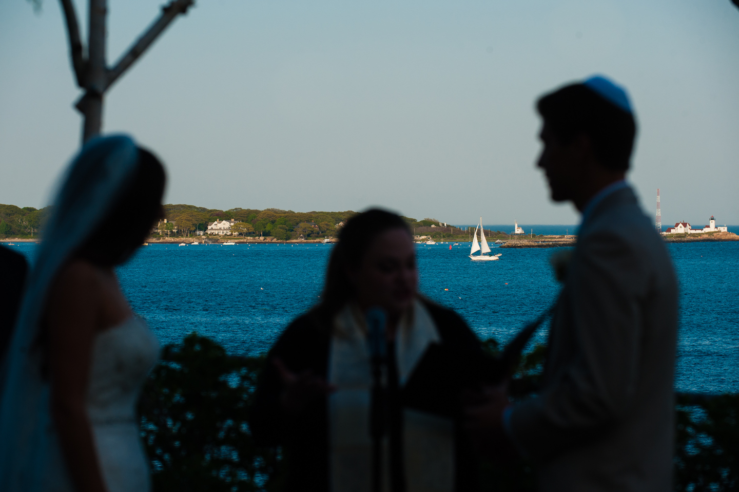 silhouette of bride and groom during their seaside wedding ceremony