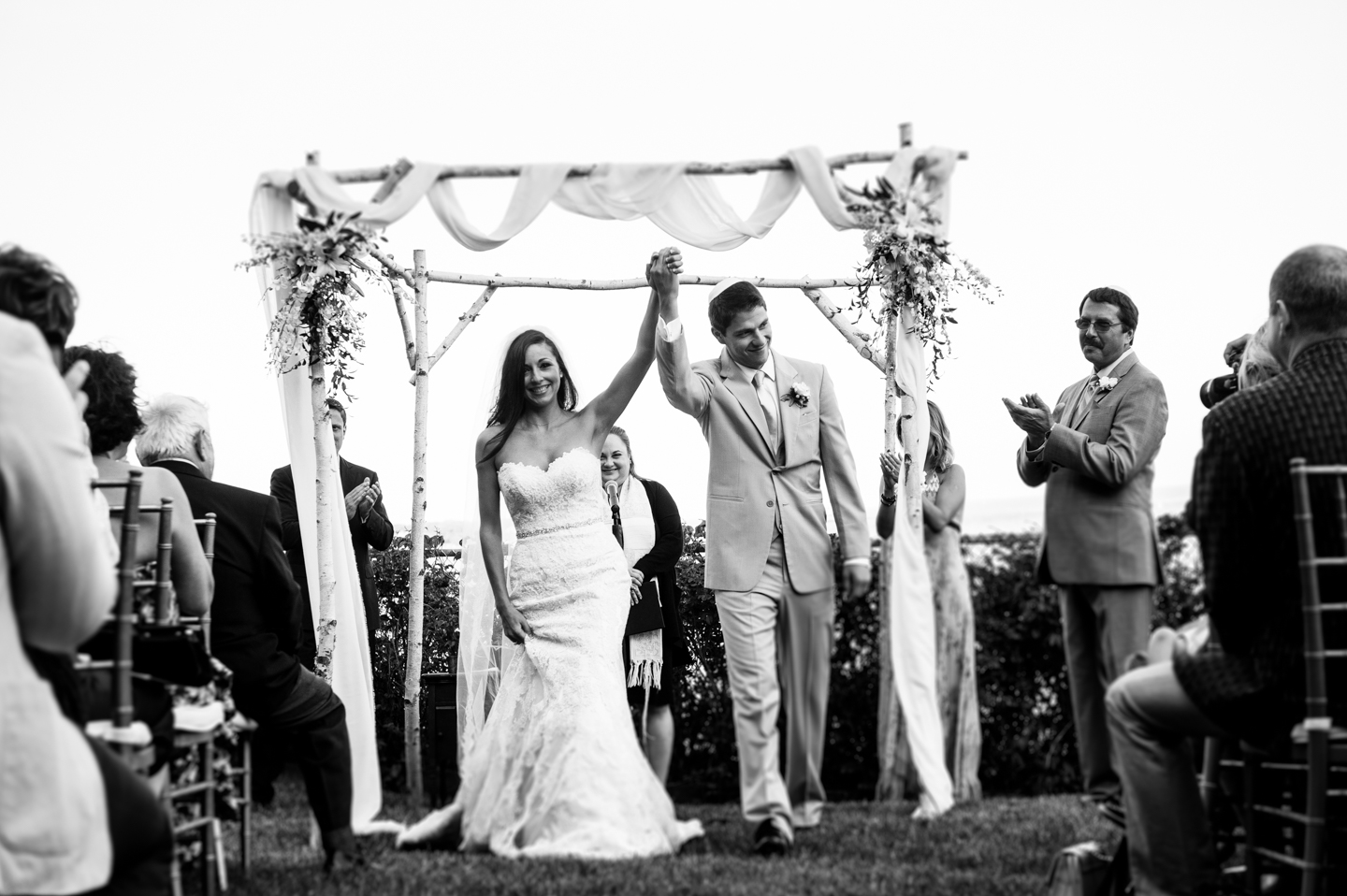 bride and groom happily walk down the aisle after their wedding ceremony at Hammond Castle