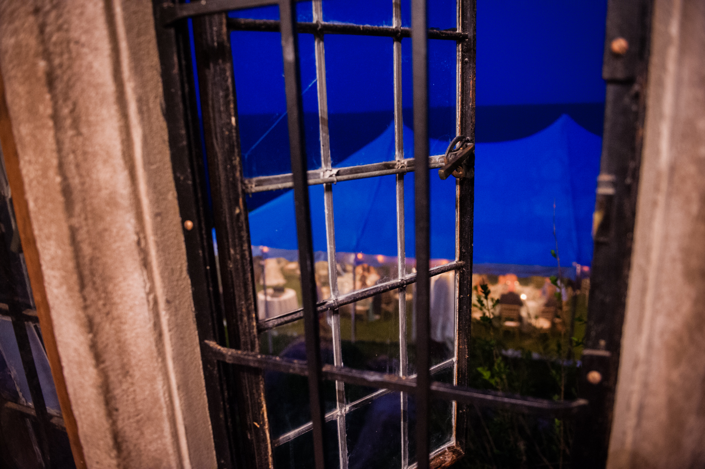 a view of the reception tent through a window at Hammond Castle