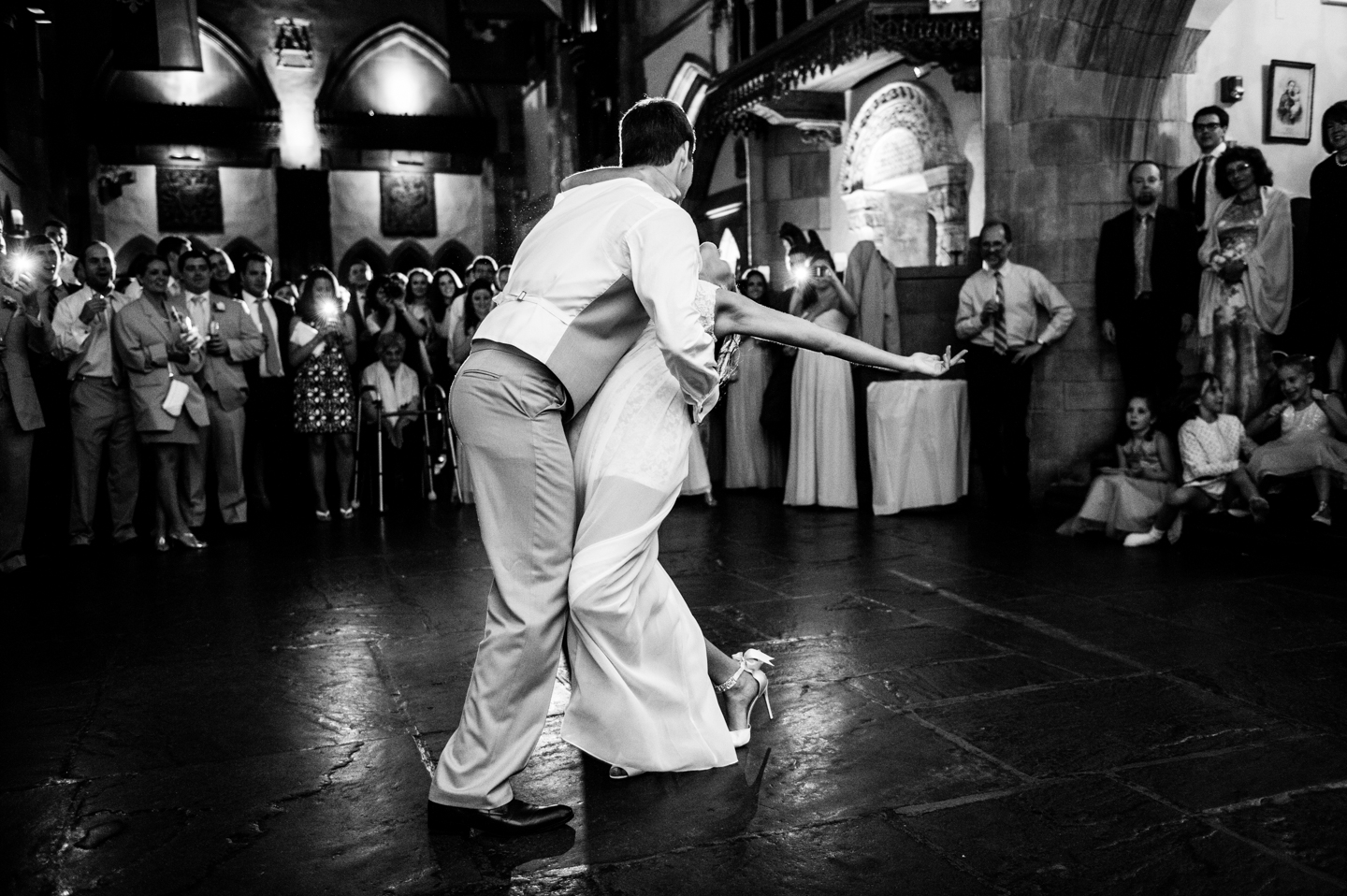 groom dips his bride during their fun first dance 