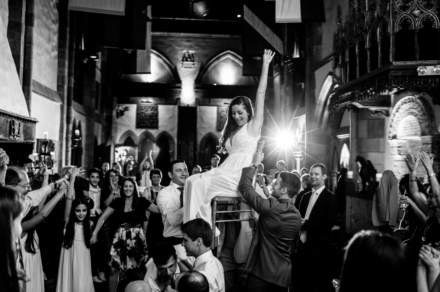 Bride lifted up in chair during the Hora 