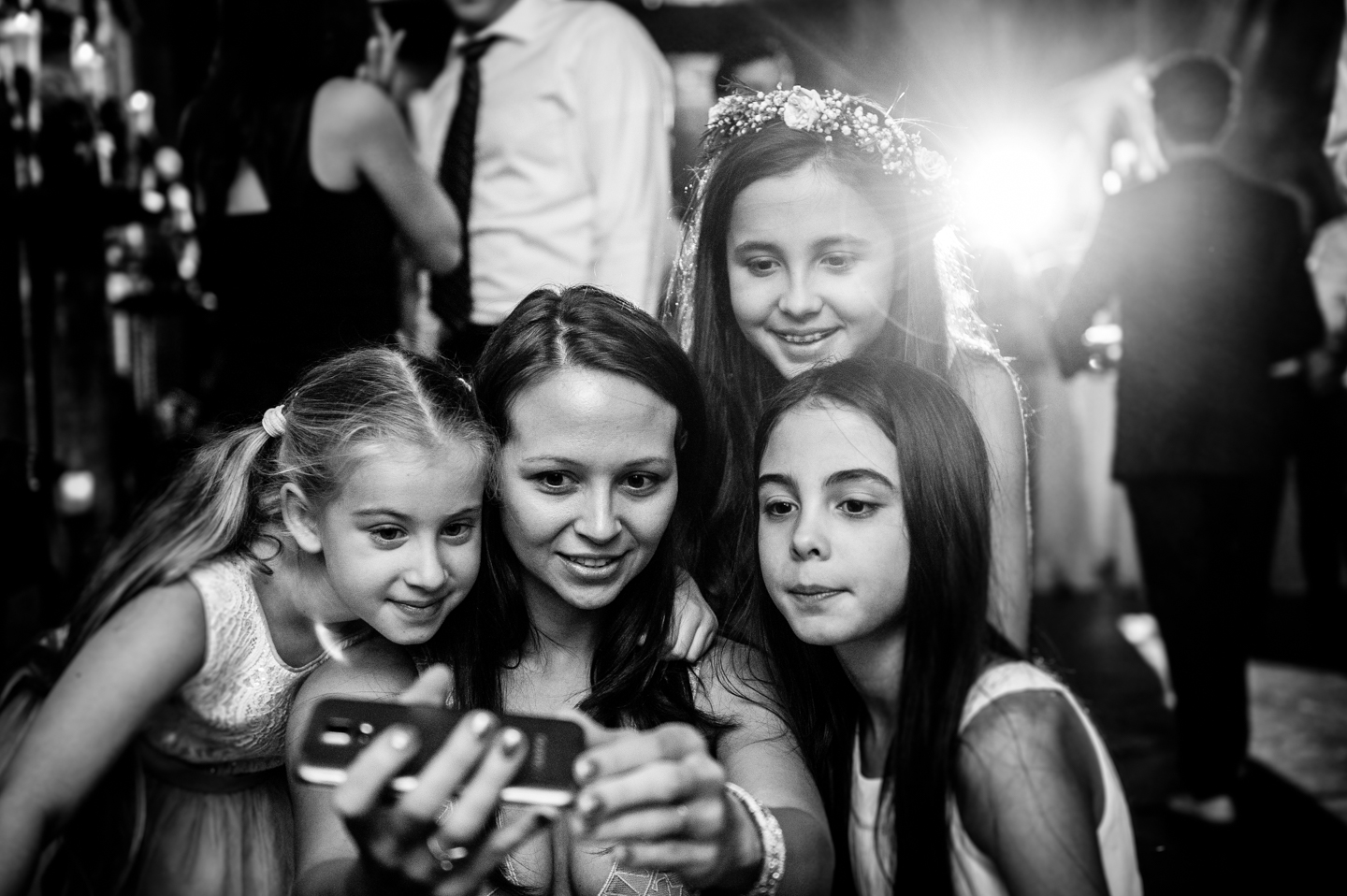 Flower girls and a guest take a self portrait during wedding reception at hammond castle