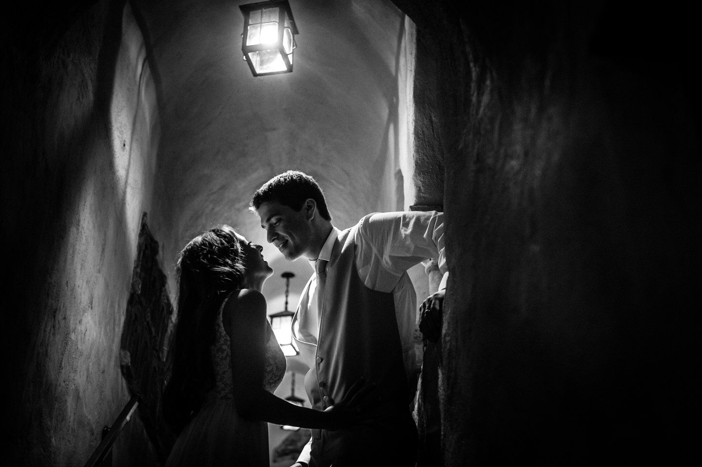 bride and groom almost kiss in gorgeous spanish archway