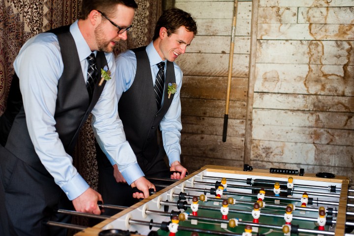 The groom and his groomsmen play some foosball before he gets married 