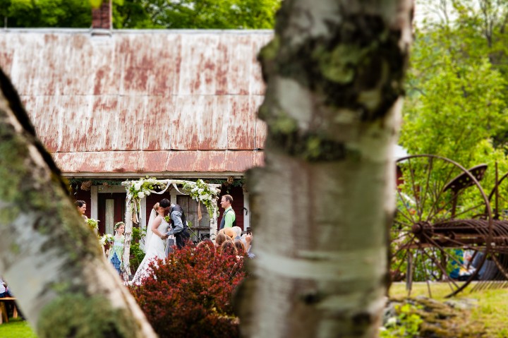 bride and groom change their first kiss as husband and wife after their outdoor ceremony 