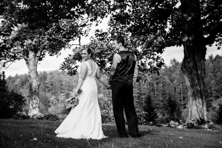 Beautiful bride looks back over her shoulder during a couples portrait 