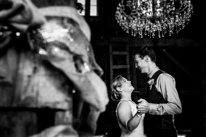 Bride and groom smile at each other during their first dance 