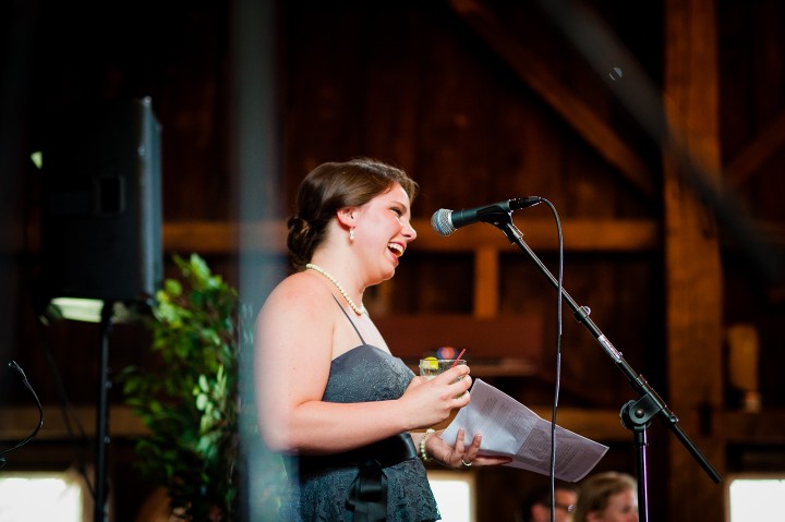 Maid of honor gives funny speech during a barn wedding reception 