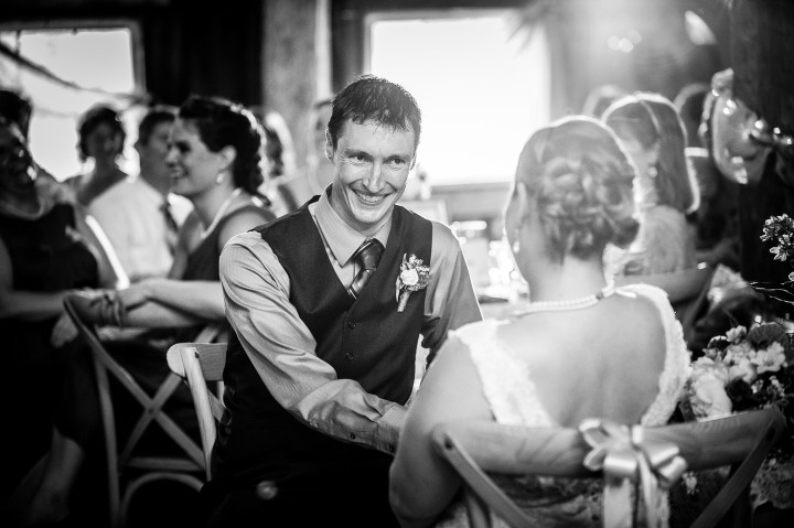 groom gives bride a sweet smile during a toast 