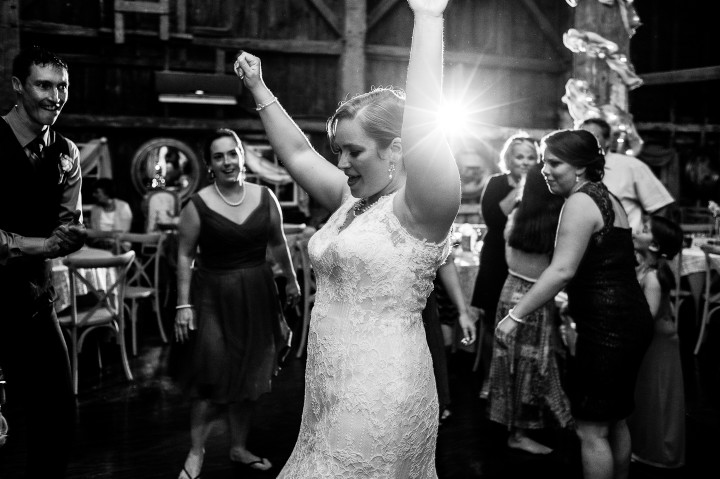 bride dances during her barn wedding reception