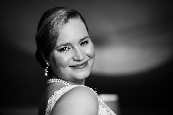 elegant bride smiles over her shoulder before her ceremony at Bishop Farm 