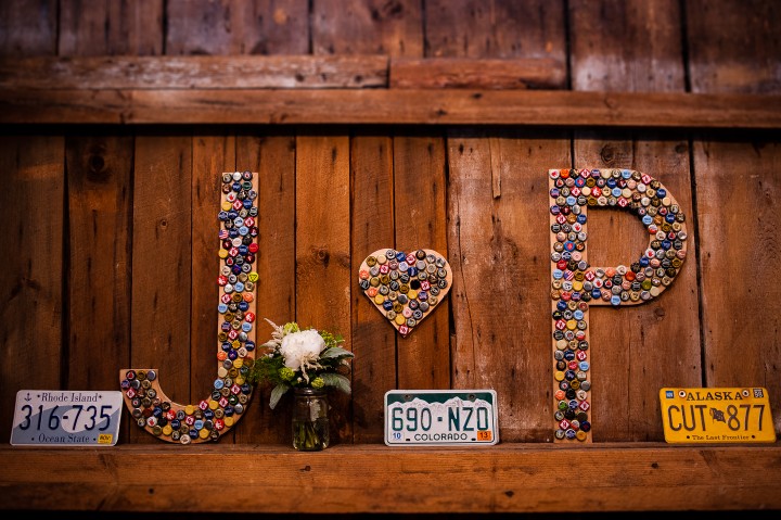 bride and groom made custom signs out of bottle caps with their initials  