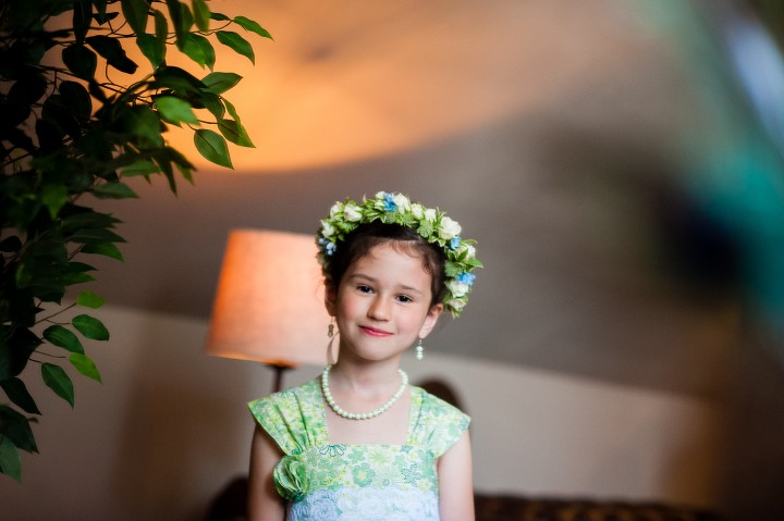 adorable flower girl with handmade flower girls dress smiles for a pictures