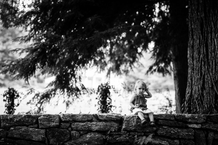 Adorable baby girl sit on gorgeous brick wall during her photography session