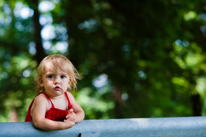 little girl stares down the camera during her baby portrait session 