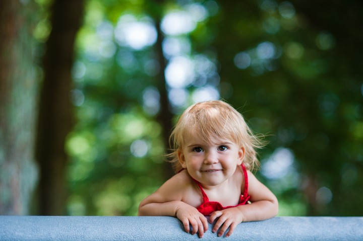 Toddler girl smiles during her portrait photography session at Carl Sandburg home