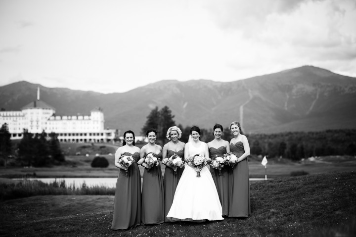 beautiful bride and her bridesmaids look at the camera during their mountain bridal portraits