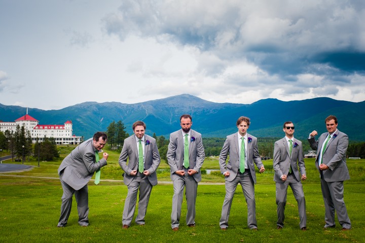 the handsome groom and his groomsmen goofing off during wedding wedding party pictures at the base of mount washington