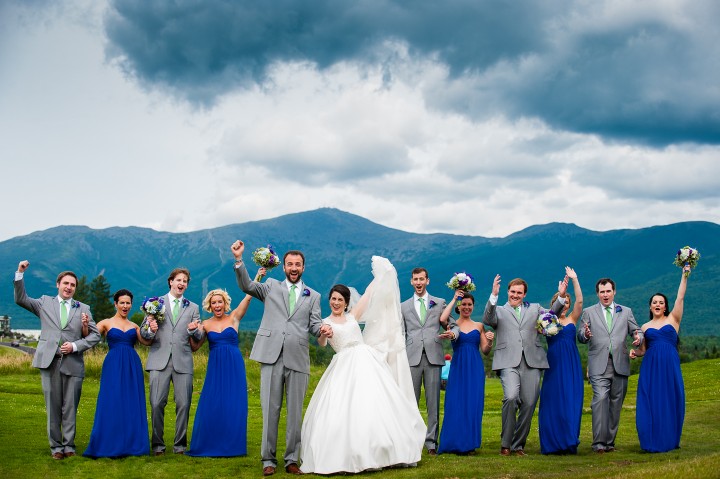 the bride and groom with their wedding party cheering for summer time mountain portraits