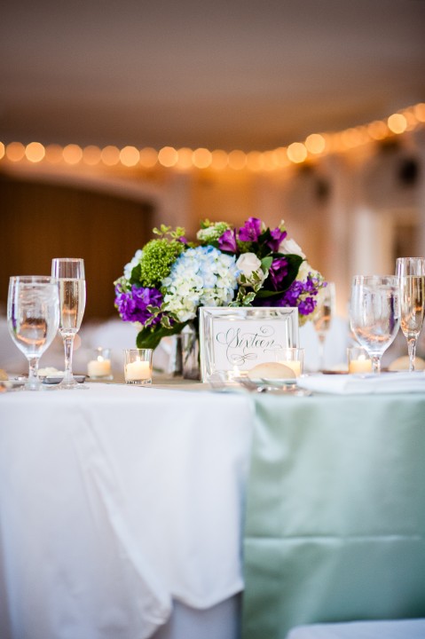 beautiful purple green and blue wedding centerpieces were beautiful for this mountain wedding 