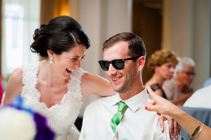 beautiful bride and a groomsmen laughing during the gorgeous ballroom wedding reception