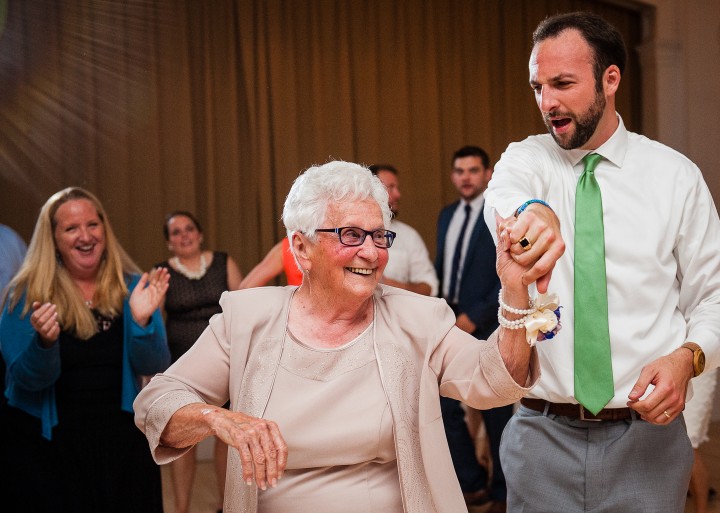 the groom dancing with the brides grandmother during a very fun wedding reception