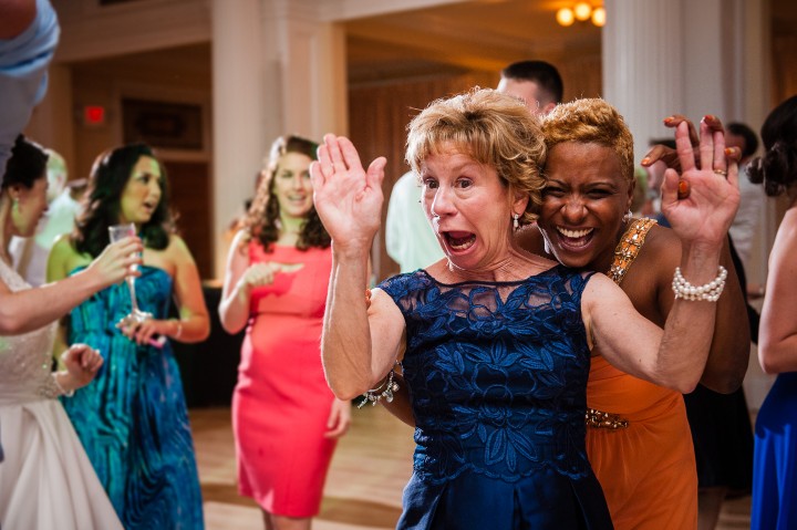 two weddings guests being goofy for the camera on the dance floor of an omni mount washington wedding