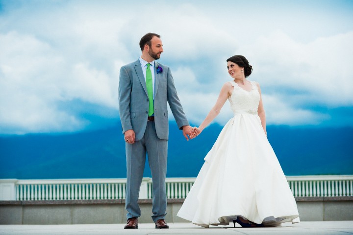 bride and groom holding hands for a wedding portrait on the mountain terrace of the mount washington hotel