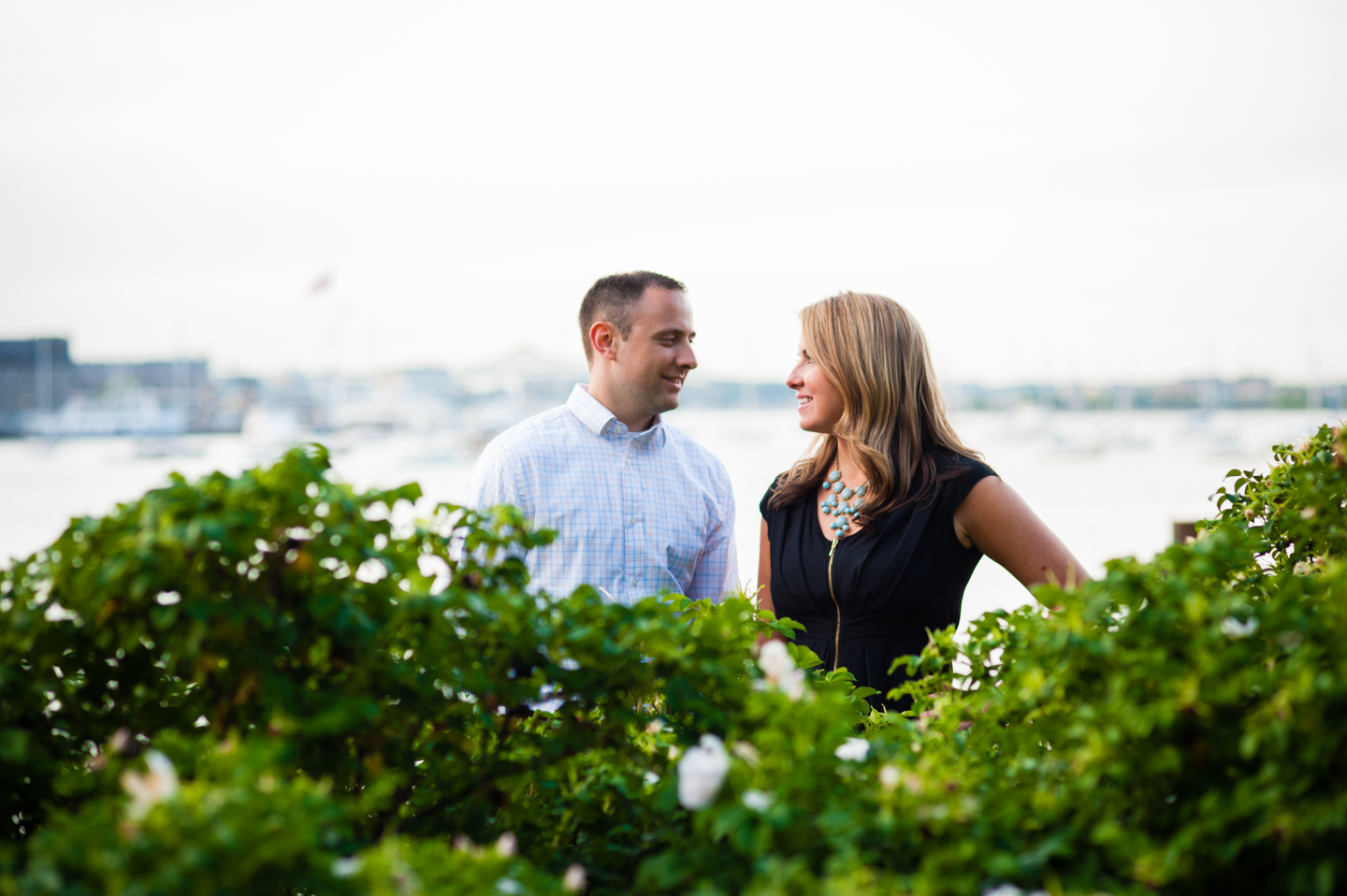 adorable couple steals a glance at one another during their engagement session 