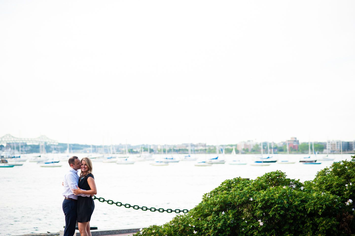 handsome soon to be groom gives his finance a kiss on the cheek 