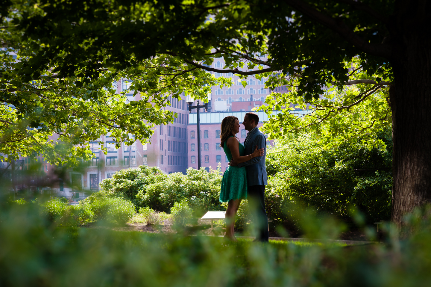 Silhouette of engaged couple under trees