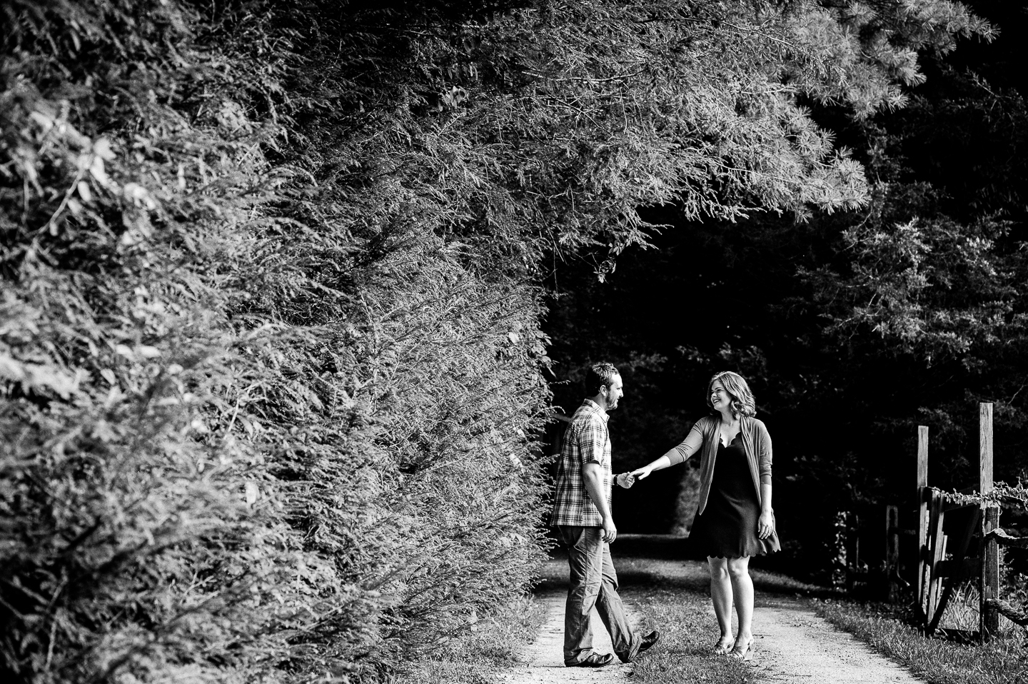 black and white image of bride and groom holding hands