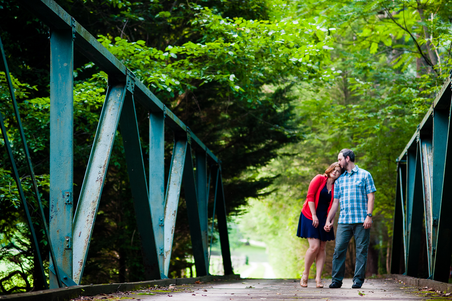 bride rests her head on grooms shoulder during the forest wedding portraits