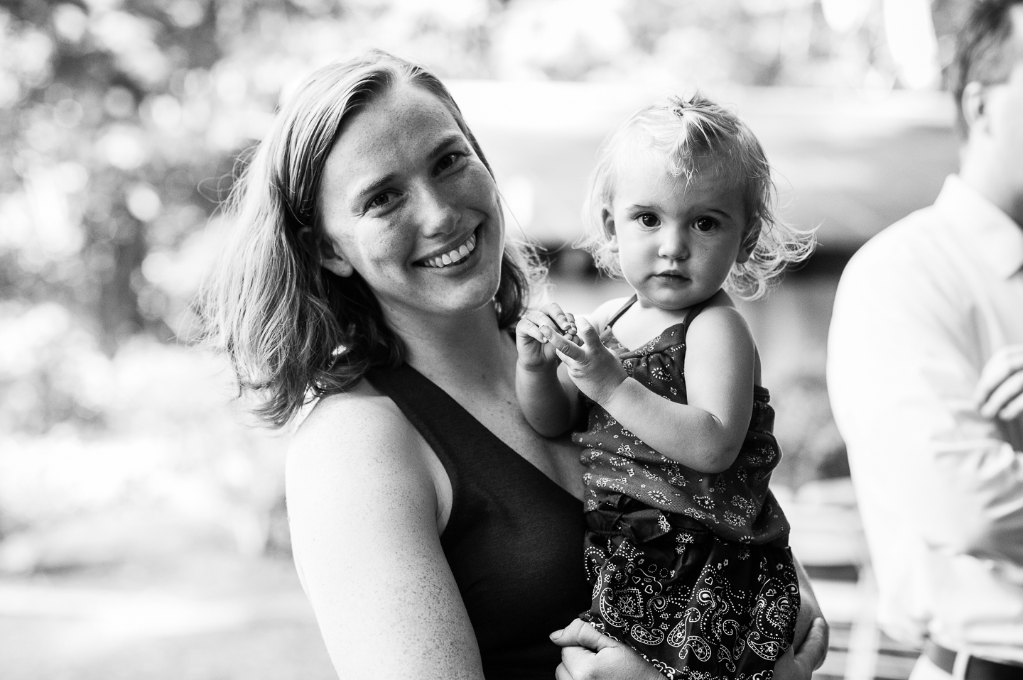 wedding guests pose for a quick portrait during backyard wedding celebration 