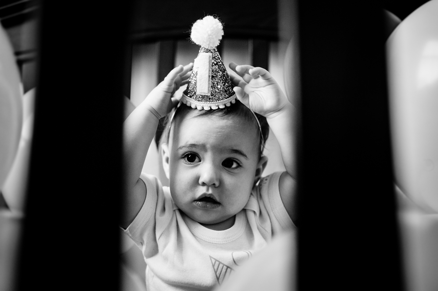 Adorable baby girl pulls her 1st year crown off her head during her 1st year birthday portrait session