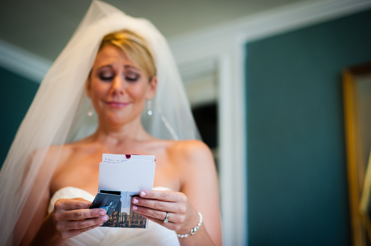 beautiful bride gets emotional as she reads the card from her soon to be husband 