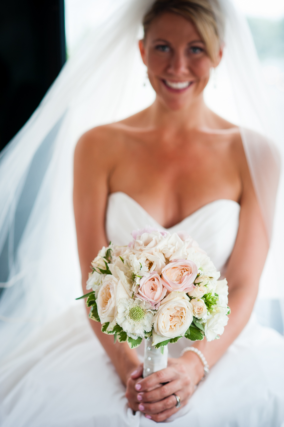 gorgeous bridal bouquet is show off by bride during the trolley ride to her wedding ceremony