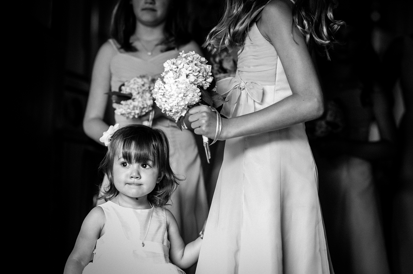 adorable flower girl looks at the aisle she is is soon to talk down 