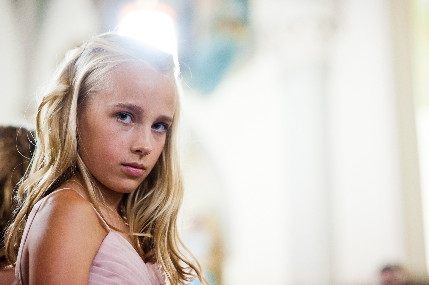 jr bridesmaid looks at camera during the ceremony 