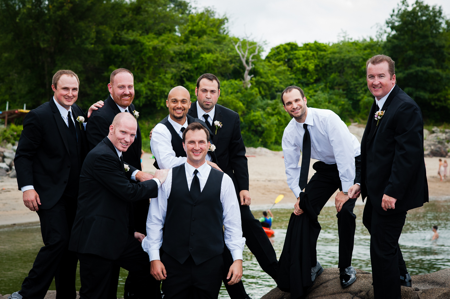 The handsome groom and his guys pose for a fun picture by the ocean 