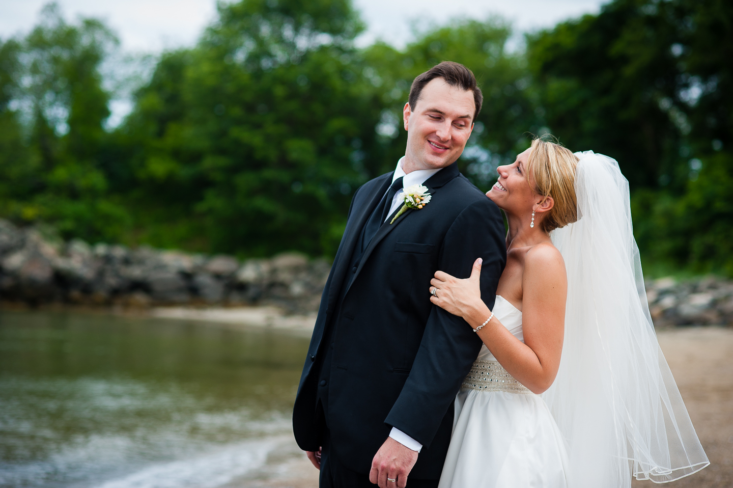 an adorable bride and groom look at each other for this couples portrait 