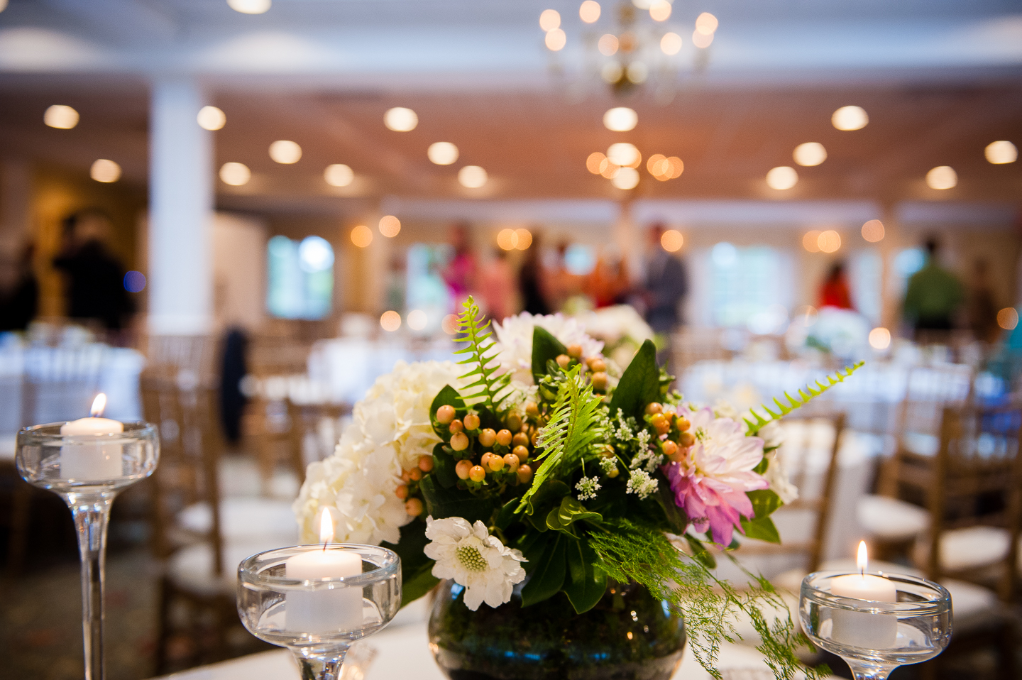 pretty twinkly lights behind one of the floral centerpieces 