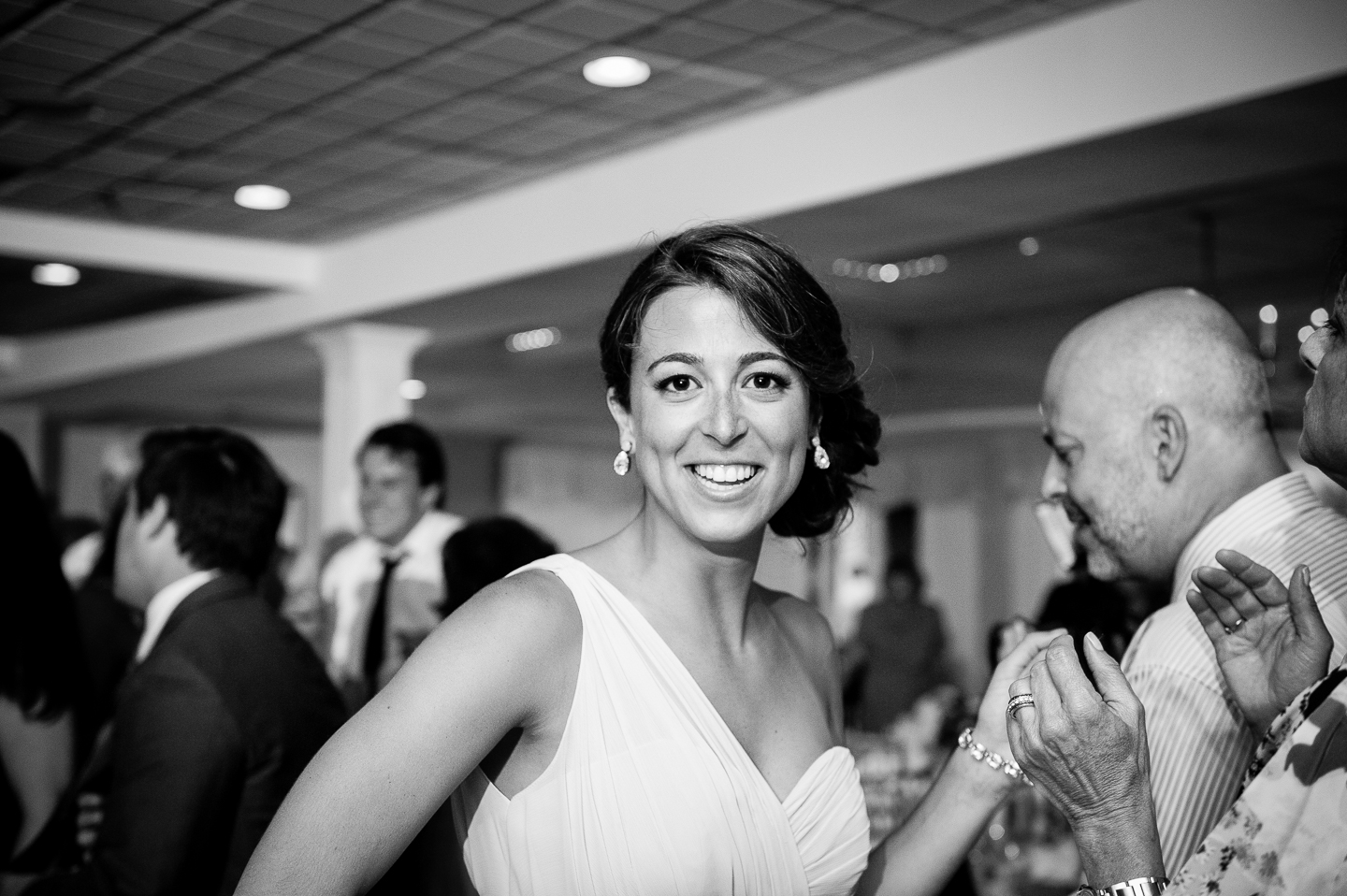 one of the beautiful bridesmaids dancing during this indoor wedding reception 